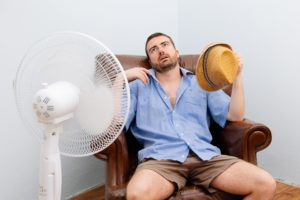 man cooling down with a fan