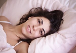 woman happy in bed with an electric blanket