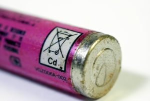 Old corroding Ni-Cad battery with KCA (Small Chemical Waste) Recycling symbol on sleeve