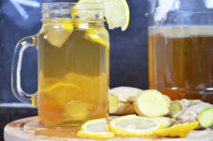 Homemade fermented raw kombucha tea with different flavorings. Healthy natural probiotic flavored drink with lemon and ginger or ginger ale.