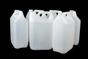 White plastic food grade container isolated on black. Often used for water alcohol or other liquids.